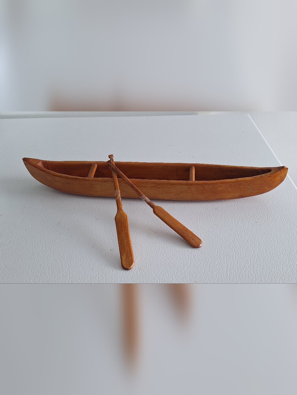 Miniature carved wooden canoe